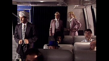 The stewardess sucks the business class passenger's erect phallus with great diligence